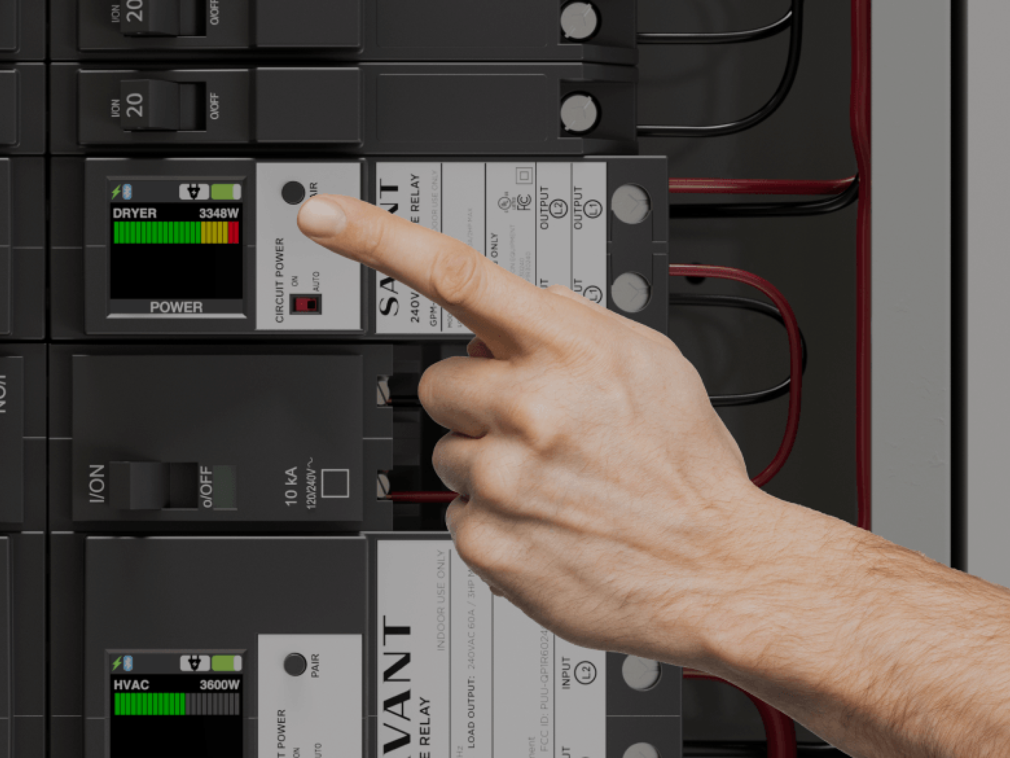 Hand pointing at a circuit breaker panel with digital displays